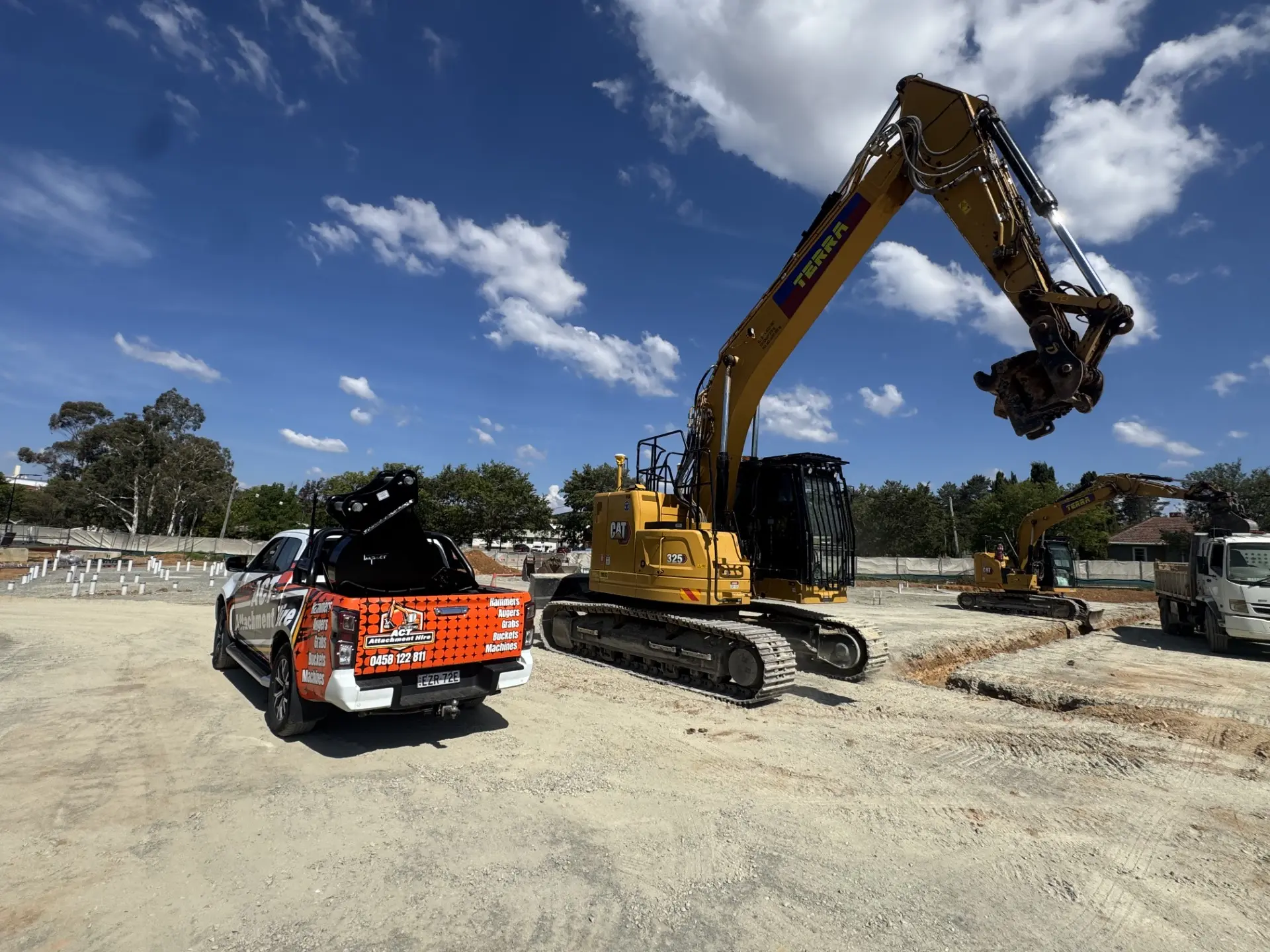Two excavators loaded on a flatbed truck ready for delivery